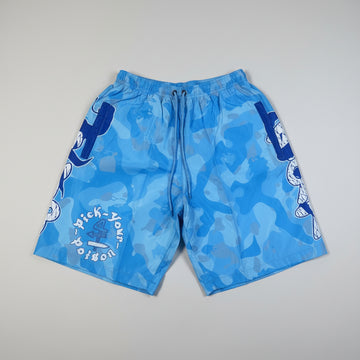 Blue swim shorts with white text on a beige surface