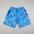 Blue swim shorts with white text on a beige surface